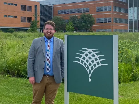 Justin Conover posing in front of the Danforth Center