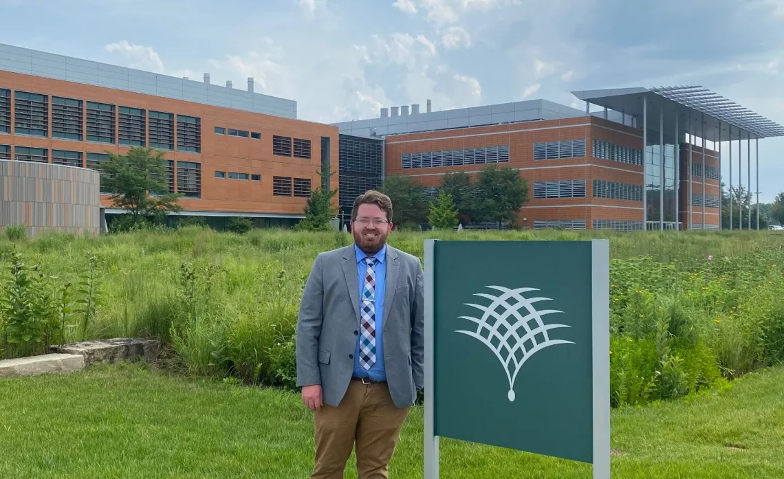 Justin Conover posing in front of the Danforth Center